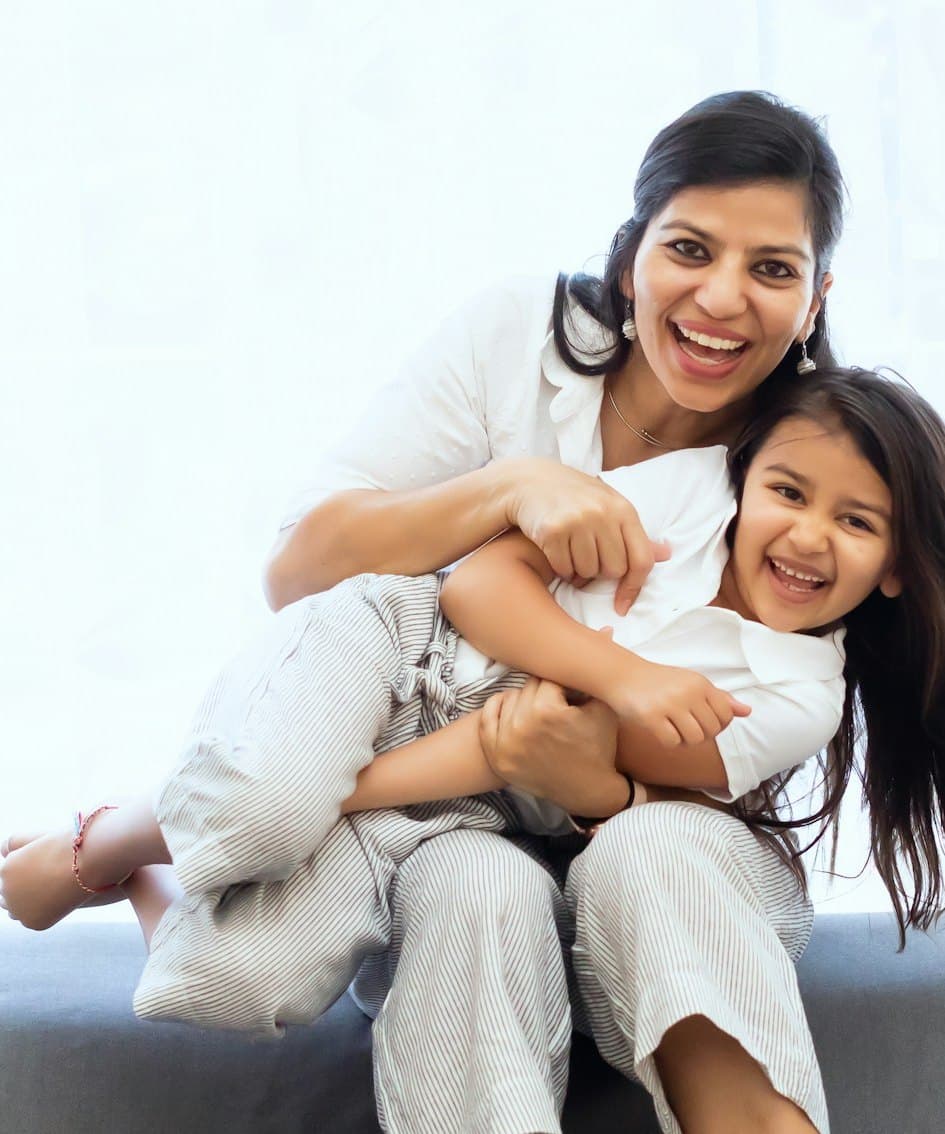 A South Asian mother and daughter sharing a joyful, close moment